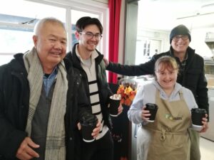 The Crumbs Project trainee works at The Parks Foundation cafe serving hot drinks to customers